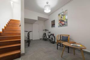 a room with stairs and a table and two bikes at Casa Marlò Centro Storico in Cividale del Friuli