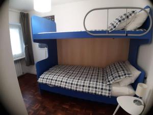 a small blue bunk bed in a room at Casa Marlò Centro Storico in Cividale del Friuli