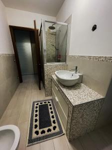 La salle de bains est pourvue d'un lavabo et de toilettes. dans l'établissement Guest House Isabel Pinto, à Santa Maria di Sala