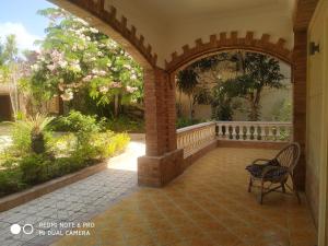 an outdoor patio with an archway and a chair at VillaJouda in Alexandria