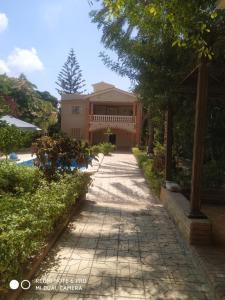 a walkway leading to a house with a pool at VillaJouda in Alexandria