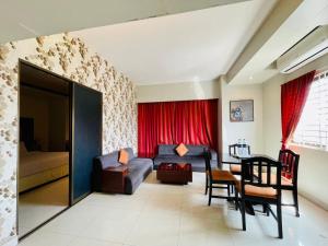 a living room with a couch and a table at Orchid Business Hotel in Chittagong