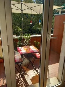 a table with an umbrella on a patio at Vito's Room in Cormano