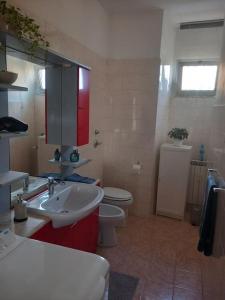 a bathroom with a sink and a toilet in it at Vito's Room in Cormano