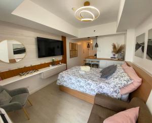 a bedroom with a large bed and a mirror at LeisureStay Studio - Azure North by THE BALI CORNER AT AZURE NORTH, Wave Pool and Man-made beach view in San Fernando