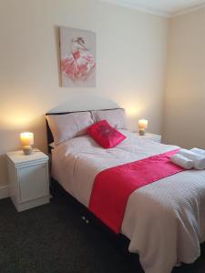 a bedroom with a large bed with two candles on tables at Blackpool Central Apartments 2 Bedroom FF in Blackpool