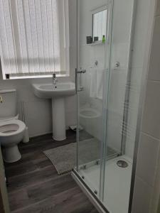 a bathroom with a shower and a toilet and a sink at Blackpool Central Apartments 2 Bedroom FF in Blackpool