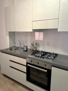 a kitchen with a stove and a sink at Classense House in Classe