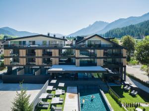 an aerial view of a building with a swimming pool at Montanaris Apartments in Villabassa