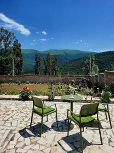 a patio with two chairs and a table with a view at Dili Dream Villa Resort in Dilijan