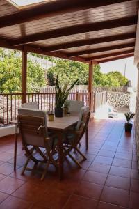 a wooden table and chairs on a patio at Mercedes (E): Campo y playa. in Breña Baja