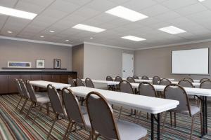 a conference room with tables and chairs and a whiteboard at Country Inn & Suites by Radisson, Jackson, TN in Jackson