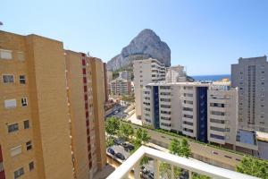 a city with buildings and a mountain in the background at La Luz Costa Calpe in Calpe