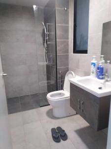 a bathroom with a toilet and a sink and a shower at Sakinah Homestay P5 Putrajaya in Putrajaya