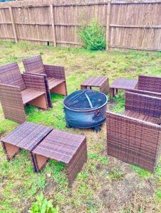 a group of benches and a fire pit in a yard at Mt Holly Home With Playground Grill Basketball, free cancel in Mount Holly