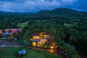 an aerial view of a resort with palm trees at Whoopers Party Hostel, Palolem in Canacona
