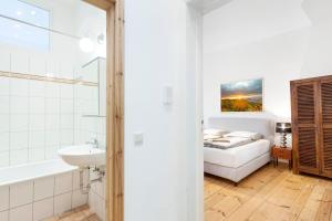 a bathroom with a sink and a bed in a room at Brüsseler Straße 39 in Berlin