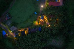 an overhead view of a house at night with lights at Whoopers Party Hostel, Palolem in Canacona