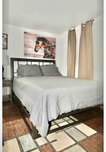 a bed in a bedroom with a picture of a horse on the wall at Mt Holly Home With Playground Grill Basketball, free cancel in Mount Holly