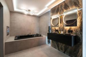 a bathroom with a sink and two mirrors on the wall at Luxury West End Oasis - Lux Spa Bath - Romantic in Edinburgh