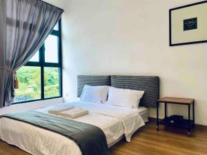 a bedroom with a large bed with a window at The Cove Hillside @ Loft 1 in Ipoh +31 photos