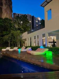 a row of inflatables sitting next to a swimming pool at The Cove Hillside @ Loft 1 in Ipoh
