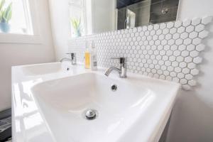 a white sink in a bathroom with a mirror at Cosy Hygge/ Scottish themed home by Loch Ness in Fort Augustus +36 photos