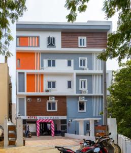 a multifamily building with a motorcycle parked in front of it at Hotel Elite Park in Tirupati