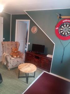 a living room with a dart board on the wall at Cozy house close to SantaVillage in Rovaniemi