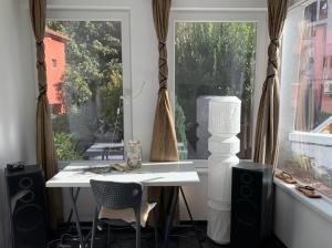 een tafel en stoelen in een kamer met een raam bij Modern flat near downtown Plovdiv in Plovdiv