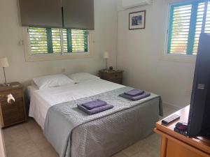 a bedroom with a bed with two towels on it at Konnos Villa in Protaras