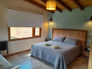 a bedroom with a bed with two towels on it at Cabañas Tierra Verde in El Bolsón
