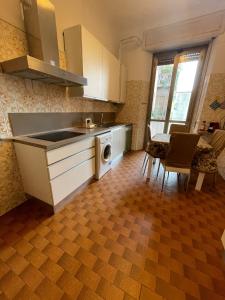 a kitchen with a sink and a dishwasher at Hostel Corner 32 in Milan