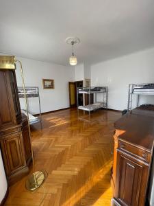 a room with two bunk beds and a wooden floor at Hostel Corner 32 in Milan
