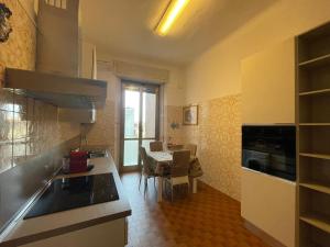 a kitchen with a counter and a table in a room at Hostel Corner 32 in Milan