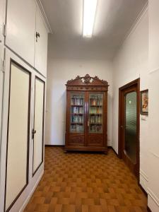 a hallway with a wooden cabinet in a room at Hostel Corner 32 in Milan