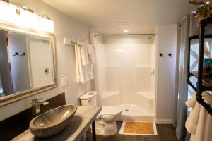 a bathroom with a sink and a toilet and a shower at Escalante Yurts - Luxury Lodging in Escalante