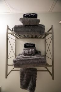 a pile of towels on a shelf in a room at Sunny Seaside Escape Perfect for Couples in Myrtle Beach