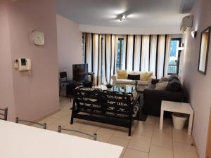 a living room with a couch and a table at 3 Bedroom Apartment in Nicosia