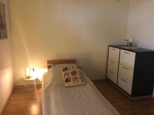 a small bedroom with a bed and a dresser at Ferienwohnung Eisenach Meyer in Eisenach