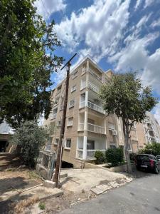 a large apartment building with a windmill in front of it at Amalia Residences in Nicosia