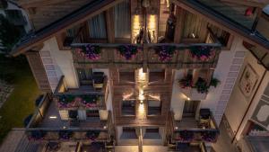 an overhead view of a building with flowers on the balconies at Sottovento Luxury Hospitality in Bormio