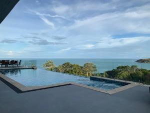 a swimming pool with a view of the ocean at IslandView Villa in Choeng Mon Beach