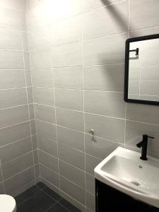 a bathroom with a sink and a mirror at CASA ADELIA STUDIO SUNGAI KARANG BALOK in Kampung Sungai Karang