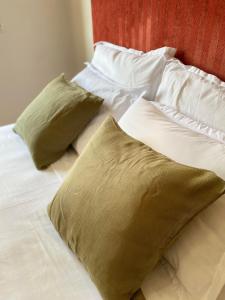 a bed with two pillows on top of it at Lac 2 apartement in Tunis