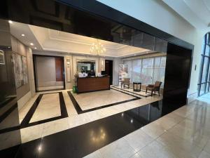 a lobby with a reception desk in a building at One Bedroom Condo with fast wifi at Eastwood Lafayette tower Quezon city in Manila