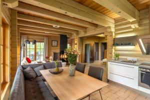 a kitchen and living room with a couch and a table at Koka Maja in Amatciems