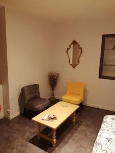 - un salon avec une table basse et une chaise dans l'établissement La chambre de Zé, à Tournus