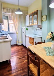 a kitchen with a wooden table and a dining room at Casa Rosi in Rome