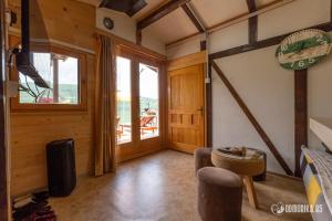 a living room with a couch and a table and a window at Splav MS in Bajina Bašta